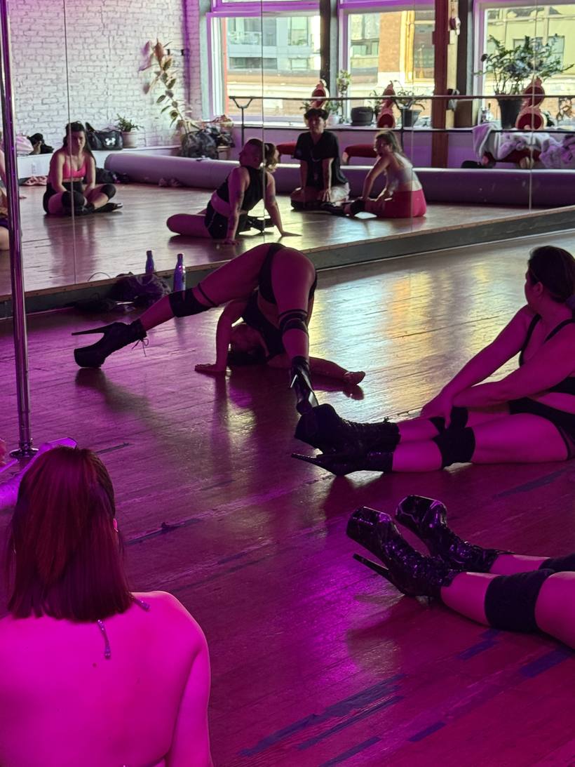 Students practising floorwork together during a heels class
